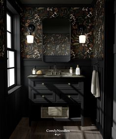 a black bathroom with floral wallpaper and dark wood flooring is featured in this image