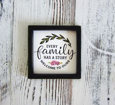 a framed sign with the words, every family has a story we welcome to ours