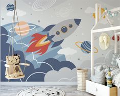 a child's room with a rocket ship wallpaper and teddy bear swinger