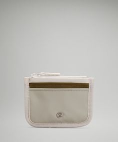 a white purse with a brown stripe on the front