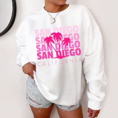 San Diego Sweatshirt California Sweatshirt Beachy Sweatshirt Preppy Sweatshirt Trendy Sweatshirt West Coast Sweatshirt California Shirt Ideal for any situation, a unisex heavy blend crewneck sweatshirt is pure comfort. These garments are made from polyester and cotton. This combination helps designs come out looking fresh and beautiful. The collar is ribbed knit, so it retains its shape even after washing. There are no itchy side seams on these sweaters.  .: 50% cotton, 50% polyester .: Medium-h Trendy White Sweatshirt For Summer, Trendy White Summer Sweatshirt, Casual Pink Sweatshirt For Vacation, Trendy White Leisure Tops, White Trendy Tops For Leisure, Trendy White Tops For Leisure, Pink Letter Print Sweatshirt For Vacation, Casual Letter Print Sweatshirt, Casual Letter Print Sweatshirt For Vacation