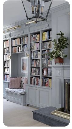 a living room filled with lots of furniture and bookshelves next to a fire place