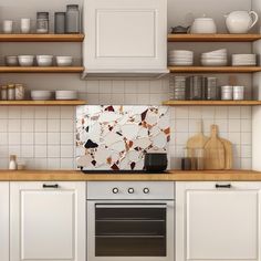 a kitchen with white cabinets and wooden counter tops is pictured in this image, there are dishes on the shelves above the stove