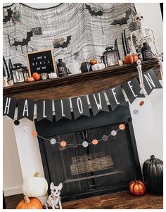 a fireplace decorated for halloween with pumpkins and decorations