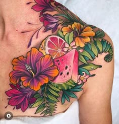 a woman's chest with watermelon and flowers on it