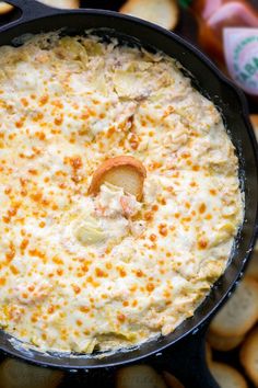 a black skillet filled with cheese and crackers