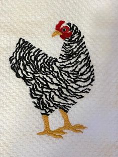 a white towel with a black and white rooster on it