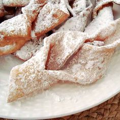 powdered sugar covered pastries on a white plate