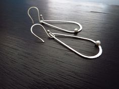 Modern, lightweight dangles made from hand forged sterling silver. These teardrop hoops have a slight hammered texture to them adding to their character. These silver earrings hang from handmade silver earwires. Length-2 inches Width-3/4 inches ~The earrings pictured are not the exact ones that you will receive, but a twin version will be duplicated with slight variations due to the handmade process. ~All jewelry is handcrafted in my home in the upstate of South Carolina. ~Every purchase is read Hand-forged Teardrop Hoop Earrings, Silver Teardrop Hoop Earrings With French Hook, Silver Hammered Teardrop Earrings, Hammered Teardrop Sterling Silver Hoop Earrings, Hammered Sterling Silver Teardrop Drop Earrings, Hammered Sterling Silver Teardrop Hoop Earrings, Sterling Silver Teardrop Hammered Earrings, Sterling Silver Hammered Teardrop Earrings, Silver Teardrop Hand-forged Hoop Earrings