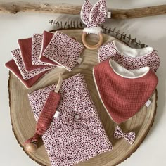 red and white cloths are laid out on a piece of wood next to a wooden ring