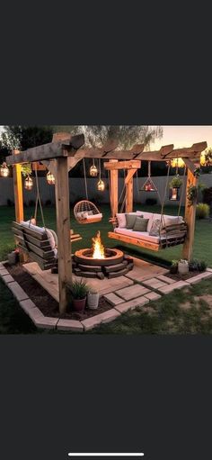 an outdoor seating area with swing chairs and fire pit