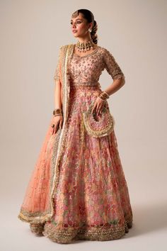 Pakistani Bridal Dress in Organza Choli Lehenga Style is adorned with hand-crafted details of dabka, gota, kora, naqshi, and threads. The choli has an alluring pink shade and the Bridal Lehenga is multi-colored, creating a lavish Lehenga Dress for the bride to wear on the big day. Detailed Description: SKU: BS2482 Detailing: Embroidery, Motifs, Naqshi, Sequins, Dabka, Gota, Kora, Threads Color: Pink, Multi-color Fabric: Organza, Net Design: Fully Embellished Dress with Embroidery Event: Bridal wear, Wedding Pink Chanderi Dress With Intricate Embroidery, Pink Raw Silk Set With Zari Work, Pink Tissue Silk Set With Zari Work, Pink Traditional Wear With Gota Work For Designer Occasions, Traditional Pink Raw Silk Dress, Pink Art Silk Choli With Zari Work, Pink Tissue Silk Choli With Resham Embroidery, Pink Raw Silk Embroidered Fabric For Reception, Traditional Pink Silk Dress