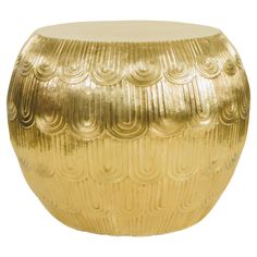 a gold colored stool with wavy designs on it