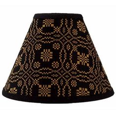 a black and gold lamp shade with an intricate design on the bottom, which is very decorative