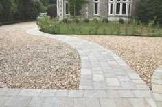 a stone path in front of a house