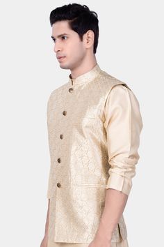 Introducing our exquisite Pearl Bush Cream hexagon Designer Embroidered Nehru Jacket, a fusion of traditional charm and contemporary elegance. Perfect for weddings, engagements, or any party occasion, this jacket exudes sophistication and style. Crafted with intricate embroidery, it adds a touch of regal flair to your ensemble. Versatile as casual wear, it pairs seamlessly with Kurta Jacket Sets, offering a refined Nehru Jacket option for men seeking timeless sophistication in their attire. In a Elegant Embroidered Outerwear For Festivals, Elegant Gold Bandhgala With Cutdana, Traditional Formal Outerwear With Gold Embroidery, Elegant Gold Nehru Jacket With Cutdana, Formal Embroidered Outerwear For Festivals, Elegant Festive Outerwear With Intricate Embroidery, Festive Elegant Outerwear With Intricate Embroidery, Elegant Festive Outerwear With Gold Embroidery, Gold Wedding Outerwear With Gold Embroidery