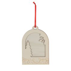 a wooden ornament hanging from a red string on a white background with an arrow