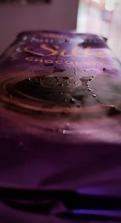 a close up view of the inside of a chocolate bar with drops of water on it