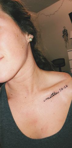 a woman with a small tattoo on her chest that says, mother is love in cursive writing