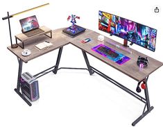 a computer desk with two computers on it