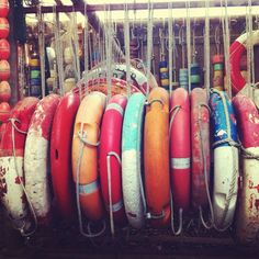 there are many different types of surfboards in the rack together, and one is for sale