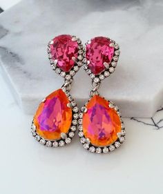 #jewelry #earrings #dangledropearrings #bridesmaidgift #bridalearrings #vintageearrings #swarovskiearrings #chandelierearrings #bridaljewelry #longearrings #longchandelierear #statementearrings #bridaldropearrings #orangeearrings #pinkearrings #orangepinkearrings Orange Chandelier, Blue Bridal Earrings, Bridal Earrings Studs, White Opal Earrings, Bridal Earrings Chandelier, Orange Crystals, Bridal Earrings Pearl, Opal Earrings Stud, Orange And Pink