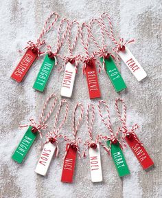 christmas tags with the words i love santa written on them hanging from twine cord