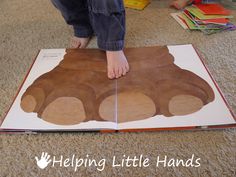 a child is playing with a book on the floor