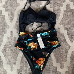 Create A Beachside Statement In Our Black And Floral Wrap Cutout One-Piece Swimsuit. Features A Front Wrap Design That Ties At The Back With Moderate Cheeky Coverage. Brand New, Tags Still On! V-Neck Back Hook Closure Wrap Tie Moulded Cups Adjustable Shoulder Straps Fixed Pads Regular Wash Fabric: 80%Chinlon, 20%Spandex Lining: 90%Polyester, 10spandex Pattern: L One Peice Bathing Suits, Grey One Piece, Cutout One Piece, Cupshe Swimsuits, 1 Piece Swimsuit, Cut Out Swimsuits, Monokini Swimsuits, Striped One Piece, Plus Size Swimsuits