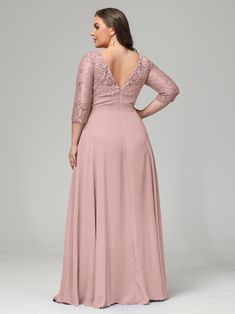 a woman in a long pink dress with an open back and lace detailing on the top