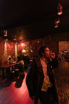 a man standing in front of a bar