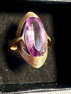 14k rind Amethyst stamped 585(European most likely Italian),  Modernist design a sweeping ribbon of textured gold captures this medium colored Amethyst faceted oval gemstone-clean elegant Mid Century design.  Condition is very good for its age any slight wear commensurate with age, pictures show the details.  Size 4 3/4, almost 1"(14.5/16") north to south on finger, wt.- 4.5 grams.  The medium shade of Amethyst is any easy color to wear, blends well with many colors, outfits.  Amethyst symbolic of Happiness, love and prosperity. Gold Amethyst Ring Stamped 14k For Formal Occasions, Modern Hallmarked Amethyst Ring For Formal Occasions, Formal Gold Amethyst Ring Stamped 14k, Modern Gold Amethyst Ring With Oval Shape, Elegant Gold Amethyst Ring, Gold Oval Amethyst Ring In Art Deco Style, Modern Gold Oval Amethyst Ring, Classic Collectible Amethyst Rings, Gold Art Deco Amethyst Ring Collectible