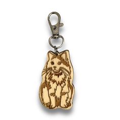 a wooden key chain with a cat on it