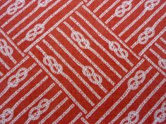 an orange and white pattern on fabric with lines in the center, as well as circles