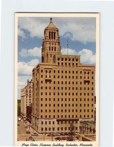 an old photo of a building with a clock tower in the middle of it's center