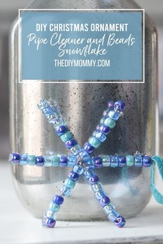 a christmas ornament in a mason jar with beads on it and the words diy christmas ornament pipe cleaner and beads snowflake