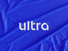 the ultra logo is displayed on a bright blue coverlet that's folded over