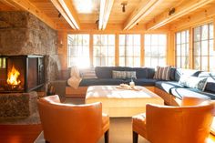 a living room with couches, chairs and a fire place in the fireplace area