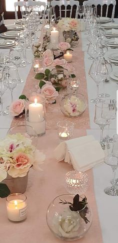 the table is set with candles and flowers