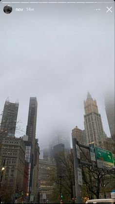 the city skyline is covered in fog and smoggy