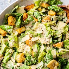 a salad with broccoli, cauliflower and croutons in it