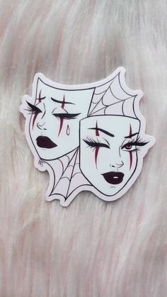 a white sticker with red eyes and spider webs on it's face