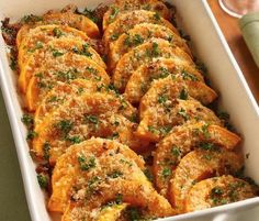 a casserole dish filled with meat and garnished with parsley