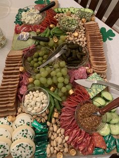 a table topped with lots of different foods and snacks on top of it's trays