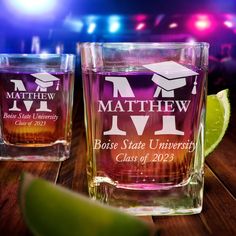 two shot glasses with graduation caps on them