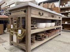 an old fashioned kitchen island with lots of pots and pans on it's shelves