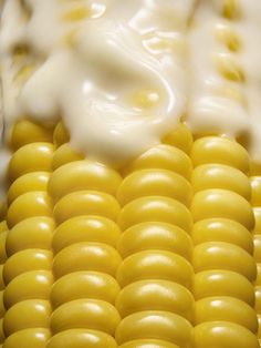 closeup of corn on the cob with yogurt and sauce in it