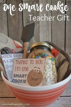 a bowl filled with cookies and other items on top of a wooden table next to the words, one smart cookie teacher gift