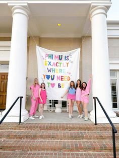 four girls in pink dresses standing on steps with a banner that says phmus exactly where you need to be