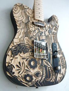 an intricately carved guitar hanging on the wall